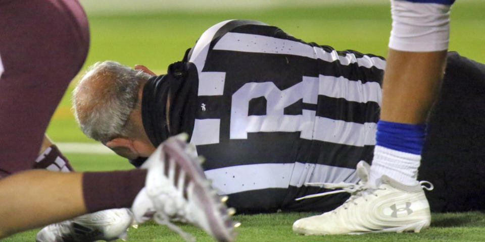 Football referee Fred Gracia lies on the ground after being charged by Duron. (Joel Martinez / The Monitor via AP)