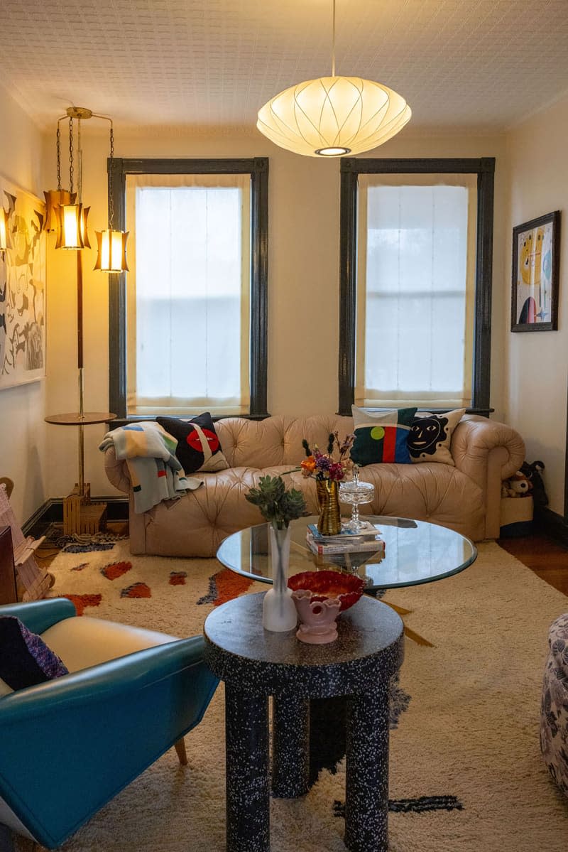 Paper pendant hung in living room with leather sofa.