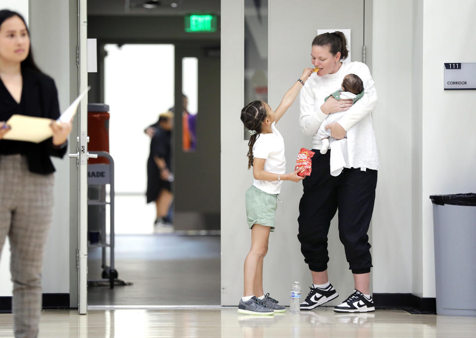 Dearica Hamby&#39;s children Amaya and Legend hang out with their grandma, Carla Hamby, during the Los Angeles Sparks&#39; media day on May 4, 2023. (Christina House / Los Angeles Times via Getty Images)