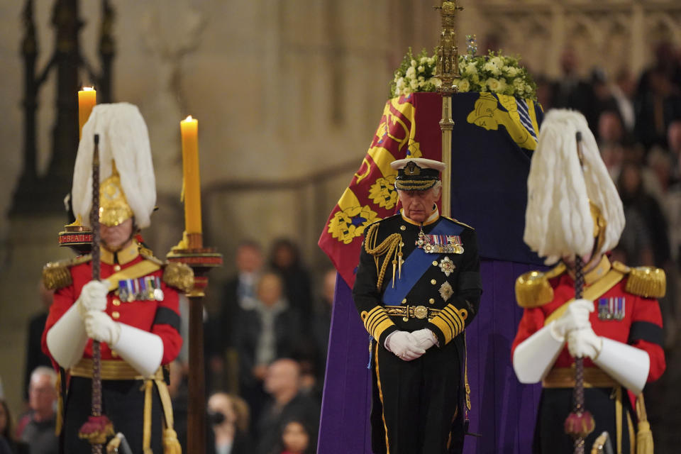 FILE - Britain's King Charles III holds a vigil beside the coffin of Queen Elizabeth II as it lies in state on the catafalque in Westminster Hall, at the Palace of Westminster, London, Friday Sept. 16, 2022. When Queen Elizabeth II’s grandfather, King George V, died in 1936, life in Britain is unrecognizable to people today. But despite almost a century of change, the images from the queen’s lying in state this week are almost exact copies of those from George V’s time. (Dominic Lipinski/Pool Photo via AP, File)