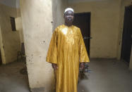 In this photo taken Friday, June 26, 2020, recovering coronavirus patient Harandane Toure, a teacher in his 50s, poses for a photo in his house in Timbuktu, Mali. Toure started taking malaria pills when he first spiked a fever but his illness only worsened. Doctors then told him he is among the hundreds now infected by the coronavirus in this town long fabled for how inaccessible it is from the rest of the world. (AP Photo/Sidi Yahia)