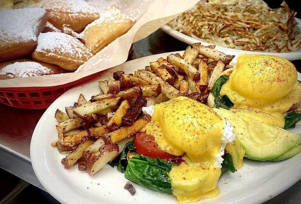 Eggs Benedict slathered in hollandaise is the most popular item at Moon’s Kitchen Cafe. Pictured: the vegetarian-style California Beni, plus housemade beignets, top left.