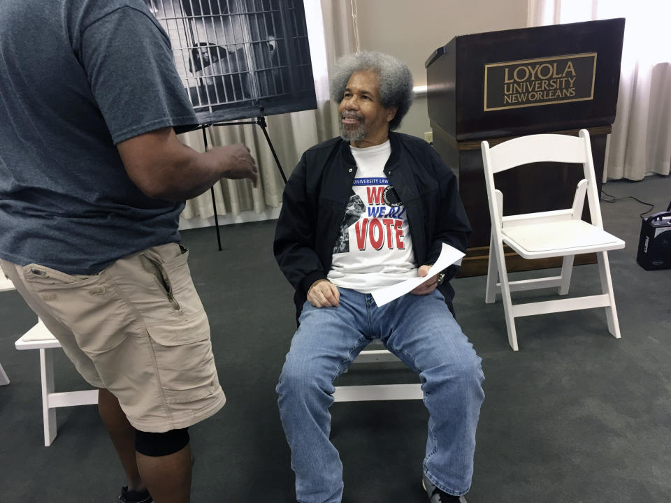 FILE - Albert Woodfox, a former Louisiana prison inmate, talks with another attendee at a news conference on a report on solitary confinement in the state at Loyola University in New Orleans, Tuesday, June 25, 2019. Woodfox, who was the last of three high-profile Louisiana prisoners known as the "Angola Three" to be released, died Thursday, Aug. 4, 2022, of complications from COVID-19, according to a statement from his family. He was 75. (AP Photo/Kevin McGill, File)