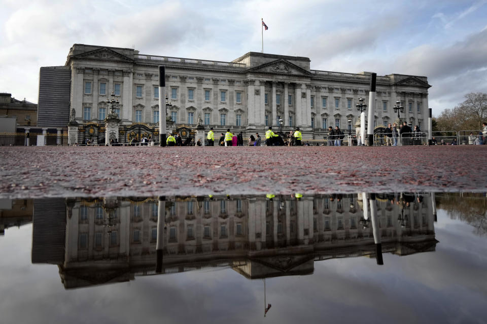 Buckingham Palace is reflected in a puddle in London, Friday, Jan. 6, 2023. Prince Harry alleges in a much-anticipated new memoir that his brother Prince William lashed out and physically attacked him during a furious argument over the brothers' deteriorating relationship. The book "Spare" also included incendiary revelations about the estranged royal's drug-taking, first sexual encounter and role in killing people during his military service in Afghanistan. (AP Photo/Kirsty Wigglesworth)