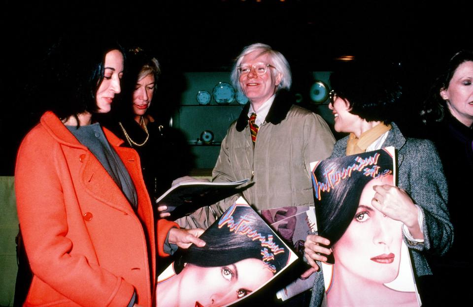 Andy Warhol celebrating Interview magazine’s Paloma Picasso cover circa 1980.