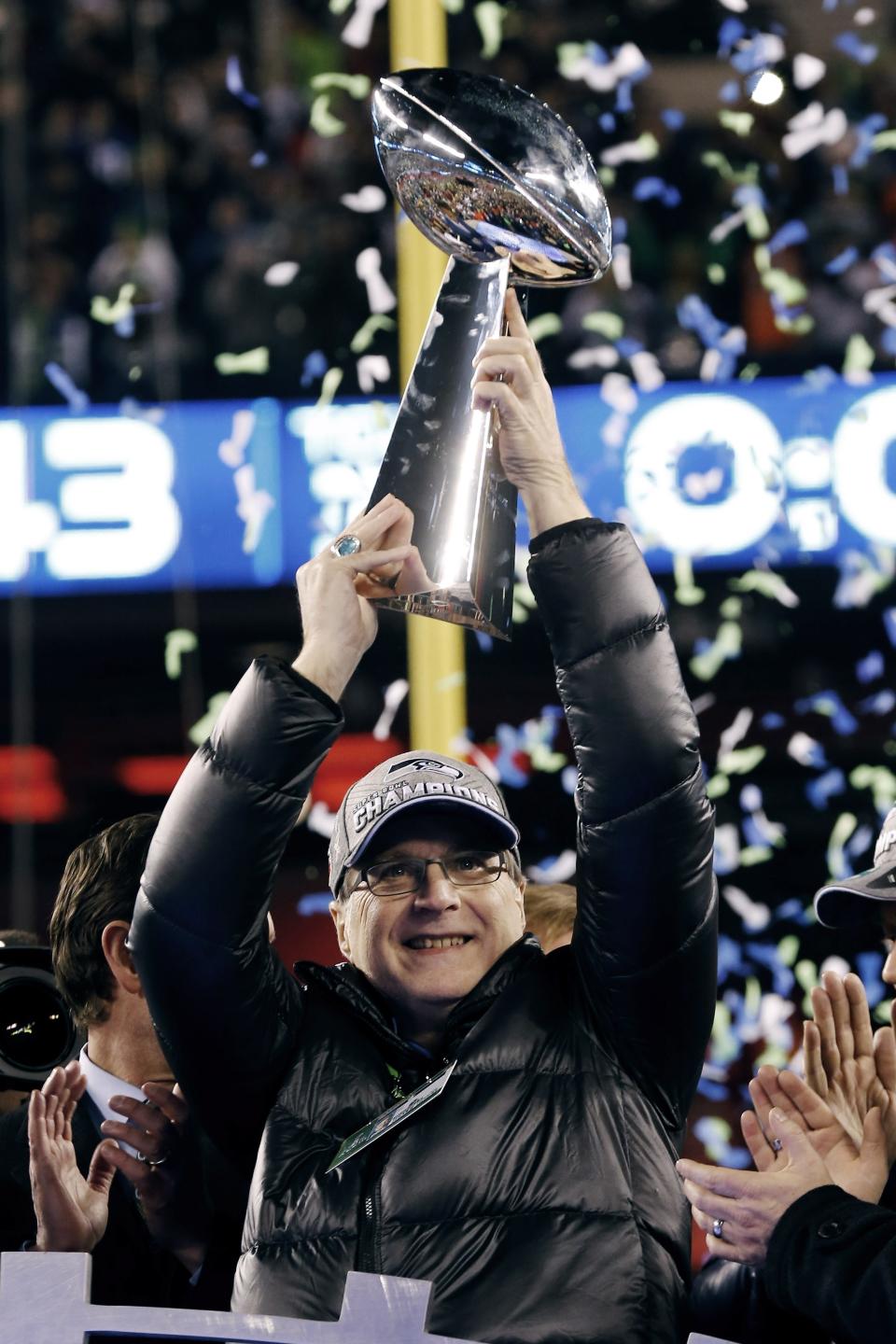 FILE - In this Feb. 2, 2014 file photo, Seattle Seahawks owner Paul Allen holds the the Vince Lombardi Trophy after the NFL Super Bowl XLVIII football game against the Denver Broncos in East Rutherford, N.J. The Seahawks won 43-8. Allen, billionaire owner of the Trail Blazers and the Seattle Seahawks and Microsoft co-founder, died Monday, Oct. 15, 2018 at age 65. Earlier this month Allen said the cancer he was treated for in 2009, non-Hodgkin’s lymphoma, had returned. (AP Photo/Paul Sancya, File)