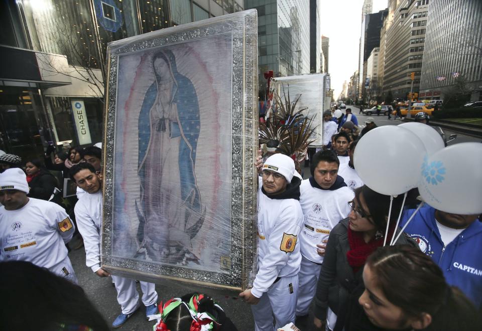 Runners in a Mexico-to-New York relay race carry a painting of the Virgen de Guadalupe during a procession in 2012. <a href="https://newsroom.ap.org/detail/NYAntorchaGuadalupana/b12f81250cc94dfbb3d4783d93e925d8/photo?Query=guadalupe%20virgin%20migrant&mediaType=photo&sortBy=arrivaldatetime:desc&dateRange=Anytime&totalCount=22&currentItemNo=20" rel="nofollow noopener" target="_blank" data-ylk="slk:AP Photo/Bebeto Matthews;elm:context_link;itc:0;sec:content-canvas" class="link ">AP Photo/Bebeto Matthews</a>