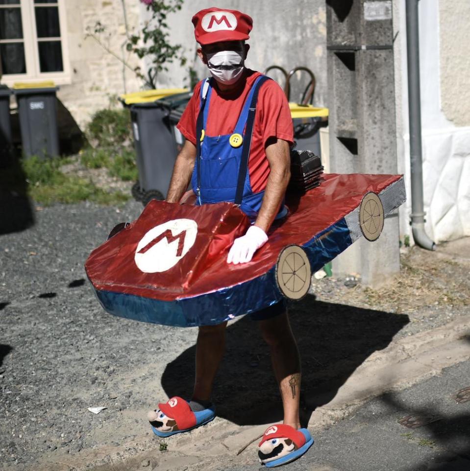 A spectator clothed as Super Mario waits for the riders during the 11th stage between Chatelaillon Plage and Poitier.