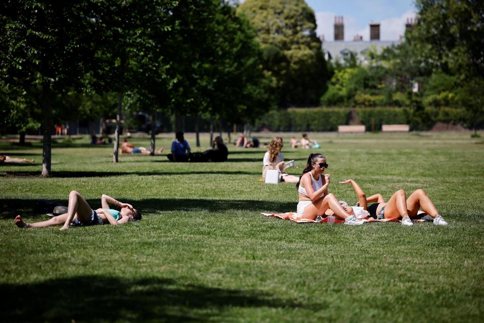 People enjoy the sunshine in Hyde Park in London where temperatures rose to scorching levels (AFP/Getty)