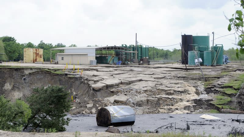 A water tank floats at the bottom of a sinkhole as it continues to grow Wednesday, May 7, 2008, in Daisetta, Texas. The massive sinkhole that was dormant for over 15 years has started expanding again.