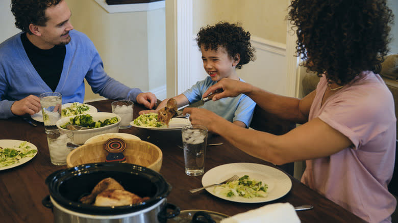 Family eating slow cooker dinner