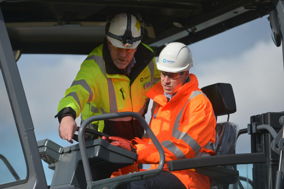 The Duke of Cambridge (right) operating an asphalt paver during a visit to the Tarmac National Skills and Safety Park in Nottinghamshire.