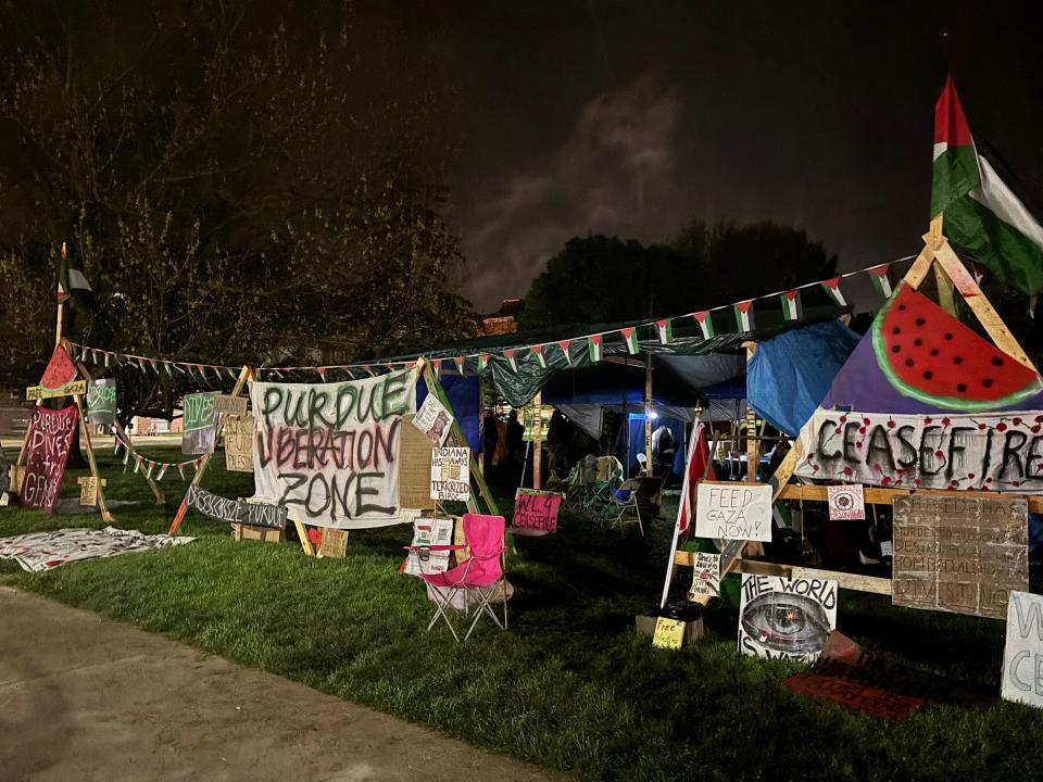 Protestors work on taking down tents during the encampment protest, Monday, April 29, 2024, at Purdue University Memorial Mall in West Lafayette, Ind.