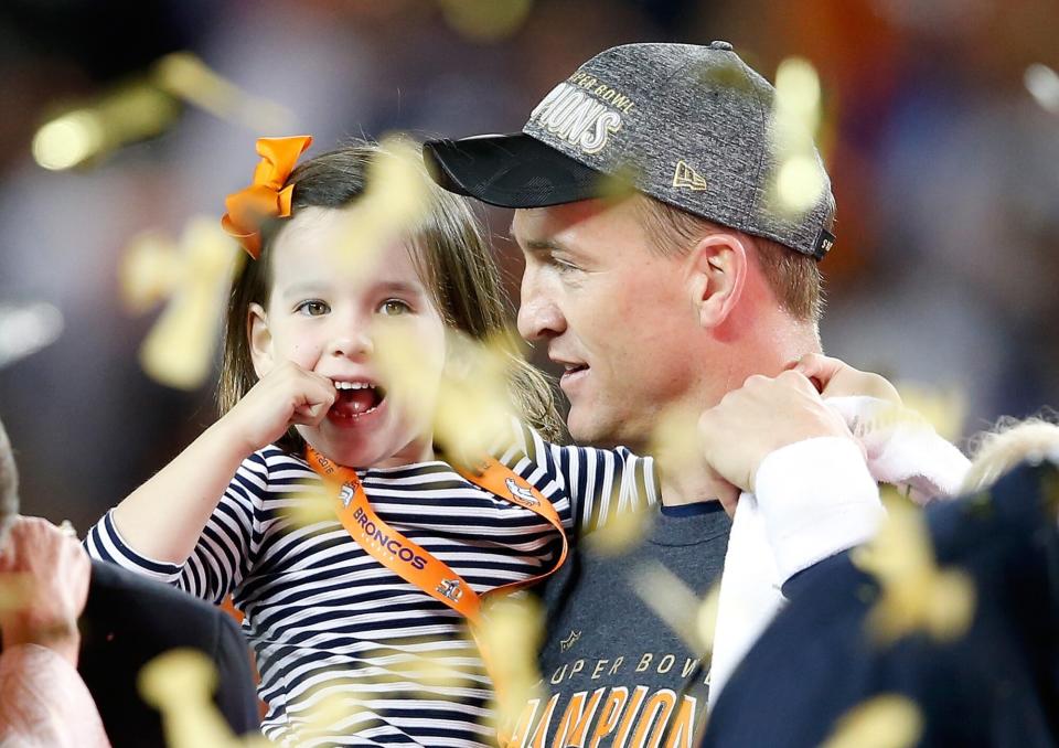 Peyton Manning #18 of the Denver Broncos holds his daughter Mosley after the Denver Broncos defeated the Carolina Panthers with a score of 24 to 10 to win Super Bowl 50 at Levi's Stadium on February 7, 2016 in Santa Clara, California