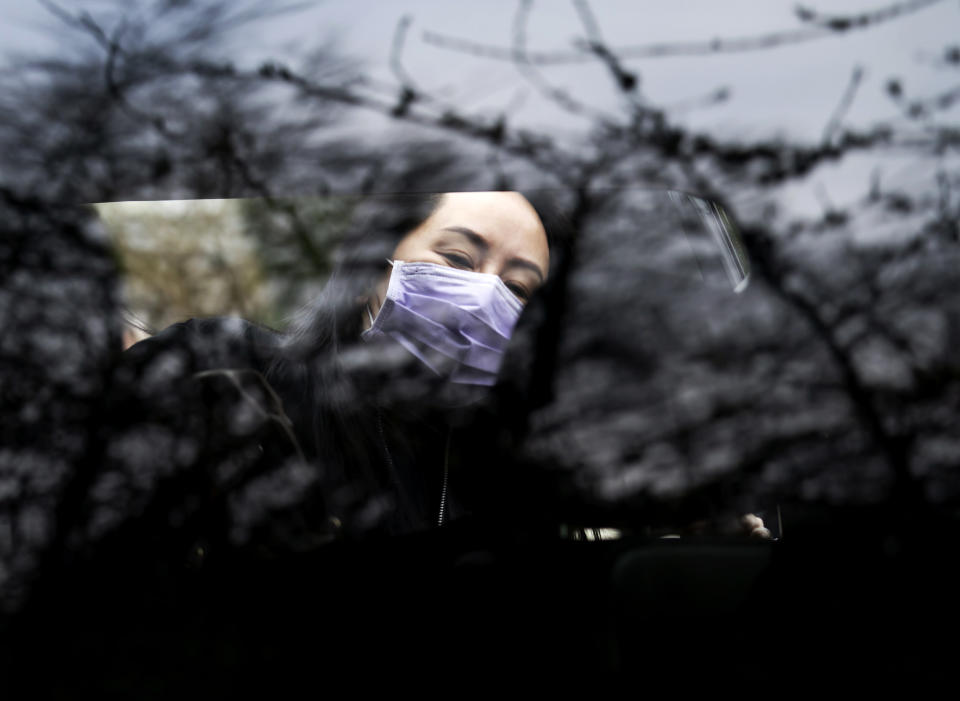 Chief Financial Officer of Huawei, Meng Wanzhou gets into her truck as she leaves her home in Vancouver, British Columbia, to go to the British Columbia Supreme Court on Friday, Jan. 29, 2021. (Jonathan Hayward/The Canadian Press via AP)