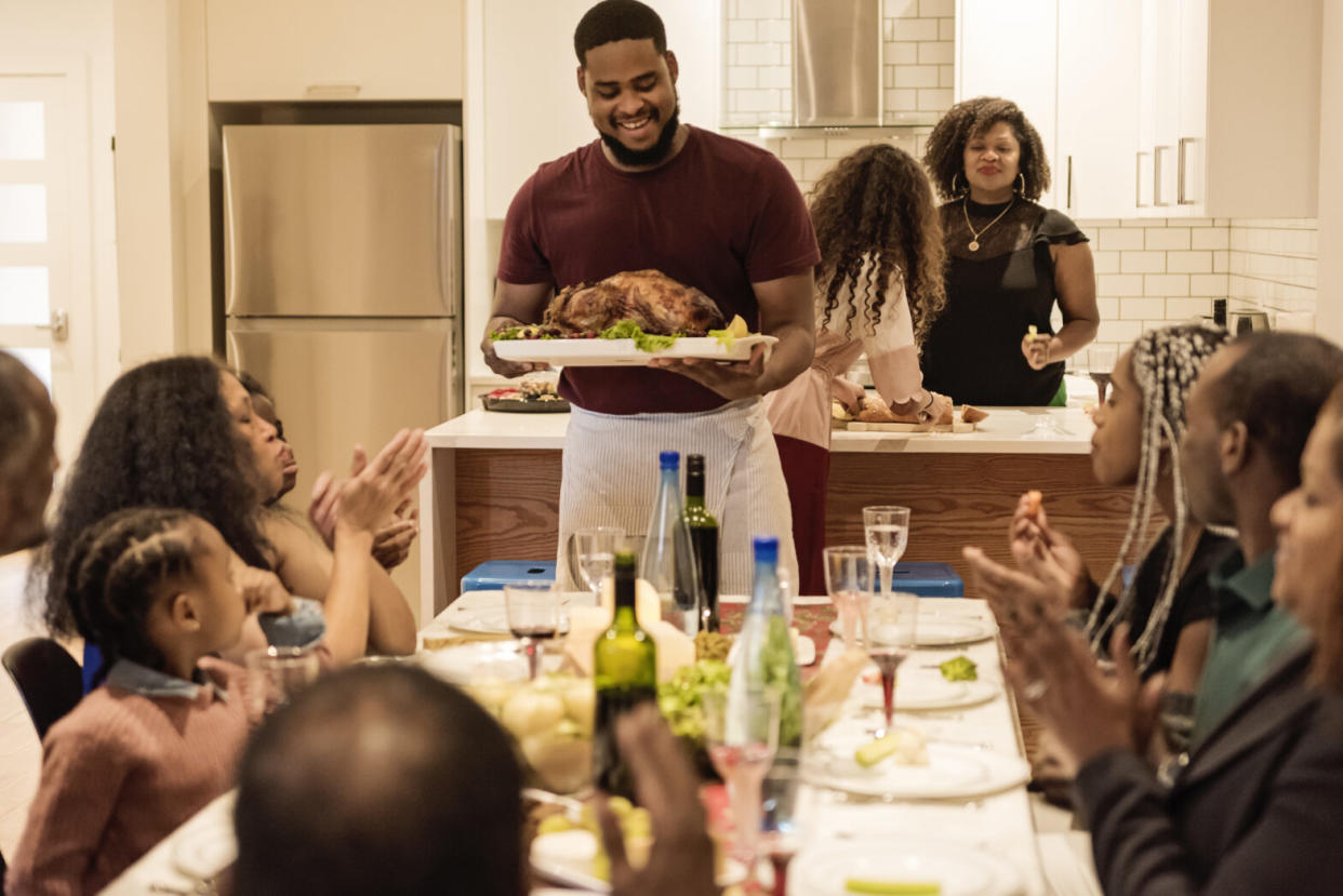 Multi-generation family enjoying Thanksgiving dinner.