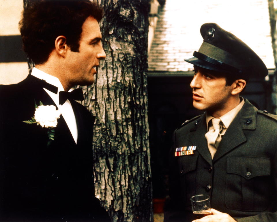 James Caan, US actor, wearing a dinner suit with a white shirt, with wing-tip collars, and a black bow tie, and Al Pacino, US actor, in military uniform in a publicity still issued for the film, 'The Godfather', 1972. The mafia drama, directed by Francis Ford Coppola, starred Caan as 'Santino 'Sonny' Corleone', and Pacino as 'Don Michael Corleone'. (Photo by Silver Screen Collection/Getty Images)