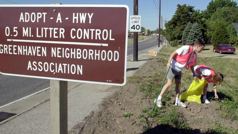 Keeping their neighborhood clean, Joe Vanover, and Keely Norris pick up trash while participating in the Greenhave Neighborhood Associations Adopt-A-Highway litter control project along Vivion Road in Kansas City, North.