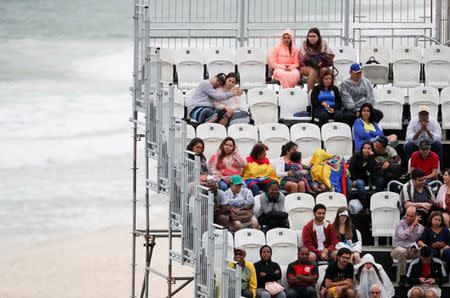 2016 Rio Olympics - Beach Volleyball - Men's Preliminary - Beach Volleyball Arena - Rio de Janeiro, Brazil - 10/08/2016. Fans watch beach volleyball on a rainy day. REUTERS/Ricardo Moraes