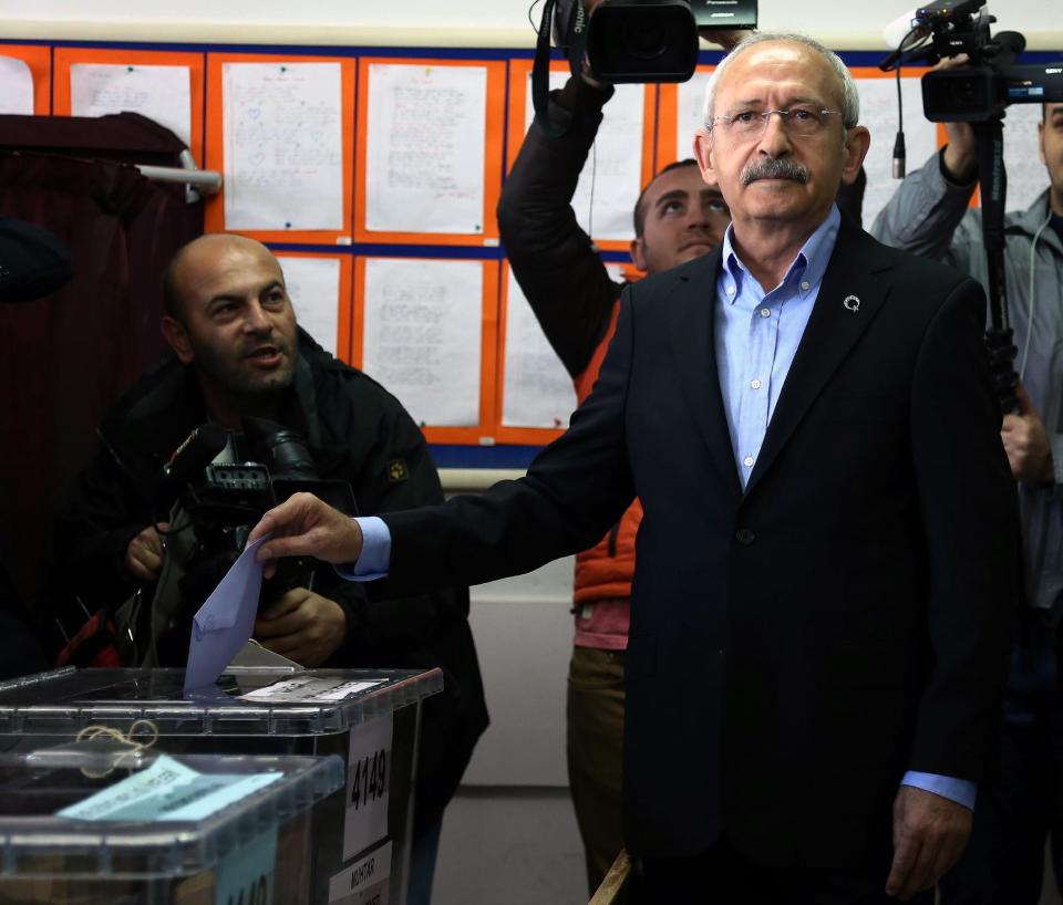Turkey's main opposition Republican People's Party leader Kemal Kilicdarogli, right, casts his ballot at a polling station in Ankara, Turkey, Sunday, March 30, 2014. Prime Minister Recep Tayyip Erdogan has a central role in Turkey's local elections Sunday even though his name won't be on the ballots. The elections are widely seen as a referendum on Erdogan's tumultuous rule of more than a decade, and the prime minister has been campaigning as if his own career were on the line. High-profile races for mayor of Istanbul and Ankara with incumbents from Erdogan's Justice or Development Party, better known by its Turkish acronym AKP, will be watched closely for signs of whether his influence is waning. The Turkish elections board says more than 50 million people are eligible to vote. (AP Photo)