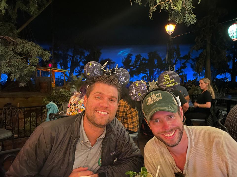 two people posing for a photo at a table in blue bayou at disneyland