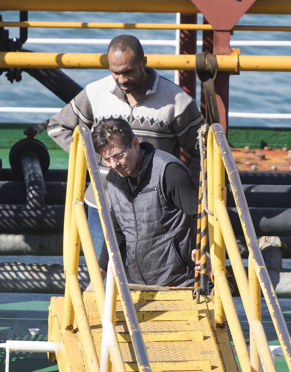 The captain stands onboard the Turkish oil tanker El Hiblu 1, which was hijacked by migrants, in Valletta, Malta, Thursday March 28, 2019. A Maltese special operations team on Thursday boarded a tanker that had been hijacked by migrants rescued at sea, and returned control to the captain, before escorting it to a Maltese port. (AP Photo/Rene' Rossignaud)