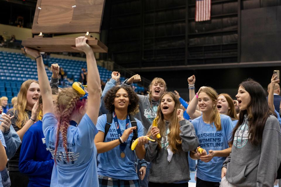 Washburn Rural girls team celebrate first place as a team at State Wrestling on Saturday, Feb. 24, 2024.