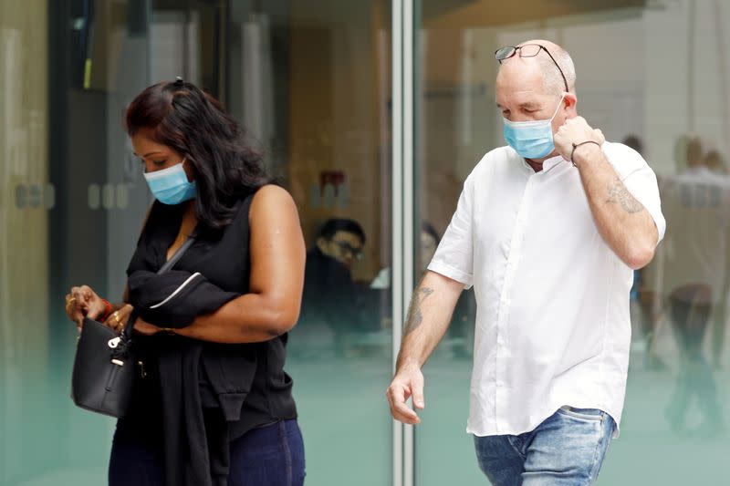 Briton Skea Nigel and partner Agatha Maghesh Eyamalai arrive at the State Courts in Singapore