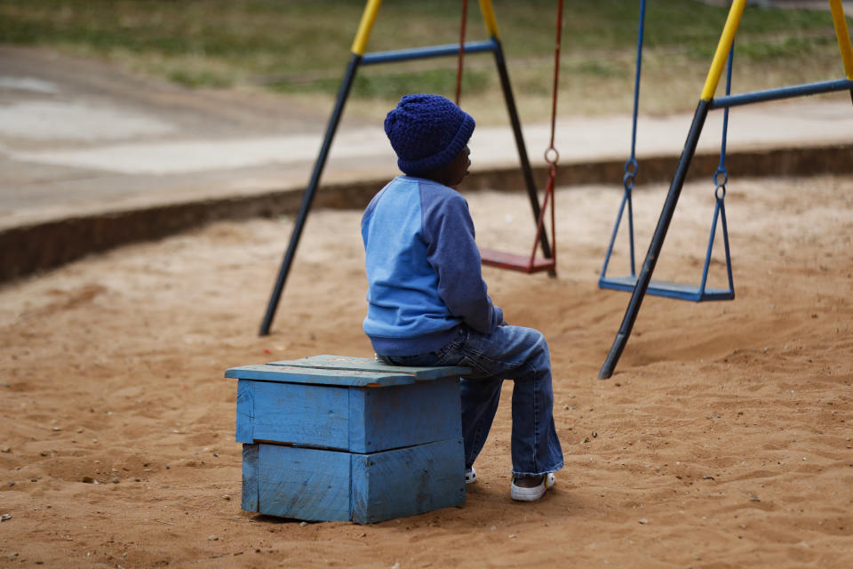 A child sits outside a classroom at the Nyumbani Children's Home in Nairobi, Kenya Tuesday, Aug. 15, 2023. The orphanage, which is heavily reliant on foreign donations, cares for over 100 children with HIV whose parents died of the disease and provides them with housing, care, and PEPFAR supplied anti-retroviral drugs. A U.S. foreign aid program that officials say has saved 25 million lives in Africa and elsewhere is being threatened by some Republicans who fear program funding might go to organizations that promote abortion.(AP Photo/Brian Inganga)