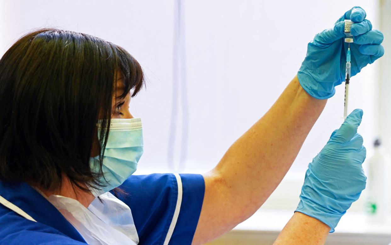 A nurse prepares a dose the Pfizer-BioNtech vaccine at a vaccination centre in Derby, central England on September 20, 2021. - Frontline health and social care workers, older people and the clinically vulnerable in Britain started on Monday to receive a booster jab against Covid 19. (Photo by Paul ELLIS / AFP) (Photo by PAUL ELLIS/AFP via Getty Images)