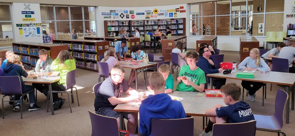 Students play some board and card games in the library during the Watertown Middle School Arrowfest on Friday, May 26, 2023.