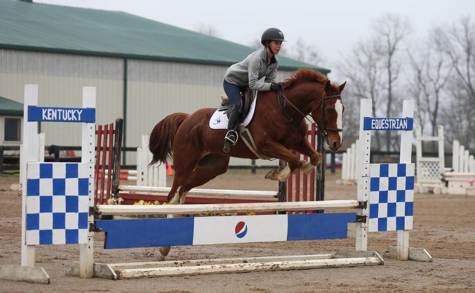 Grace Bieghler, aboard Buddy, clears a jump during Equitation practice for the University of Kentucky Equestrian Team on Monday, November 8, 2022. The team is not sponsored by the school as an NCAA Division I sport.
