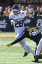 Texas A&M running back Isaiah Spiller, top, is tackled by Missouri defensive back Akayleb Evans, bottom, during the first quarter of an NCAA college football game Saturday, Oct. 16, 2021, in Columbia, Mo. (AP Photo/L.G. Patterson)