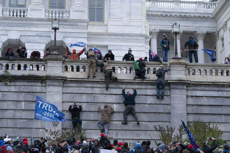 FILE - In this Jan. 6, 2021, file photo, supporters of President Donald Trump climb the west wall of the the U.S. Capitol in Washington. There is increasing concern for the safety of journalists covering protests at state capitals across the U.S., and in Washington. Packing a gas mask and helmet has become the new normal. It's starting to look, just a bit, like what foreign correspondents face in the world's conflict zones. (AP Photo/Jose Luis Magana, File)