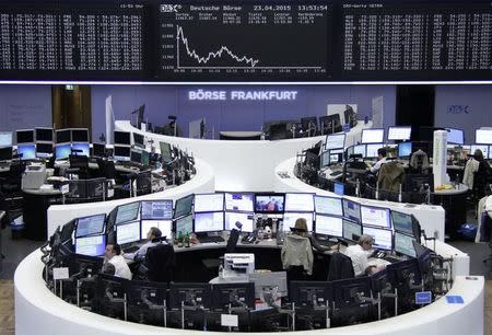 Traders work at their screens in front of the German share price index DAX board at the stock exchange in Frankfurt April 23, 2015. REUTERS/Stringer