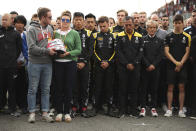 The mother and brother of Anthoine Hubert hold the helmet of Anthoine Hubert during a moment of silence at the Belgian Formula One Grand Prix circuit in Spa-Francorchamps, Belgium, Sunday, Sept. 1, 2019. The 22-year-old Hubert died following an estimated 160 mph (257 kph) collision on Lap 2 at the high-speed Spa-Francorchamps track, which earlier Saturday saw qualifying for Sunday's Formula One race. (AP Photo/Francisco Seco)