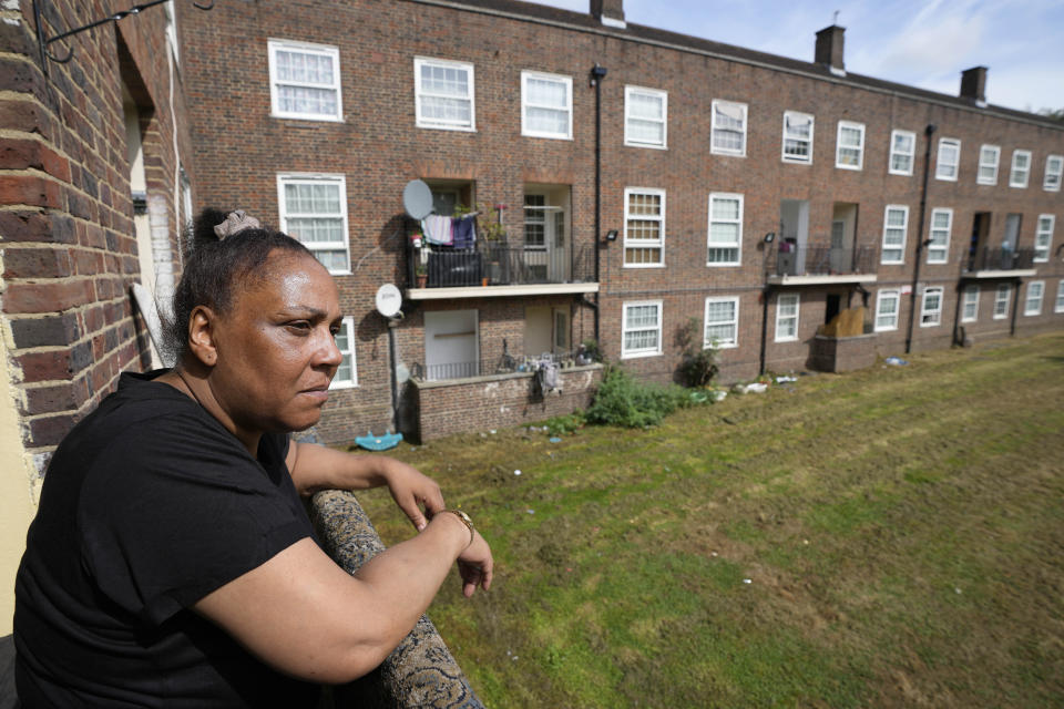 FILE -Jennifer Jones stands on the balcony of her flat in London, Thursday, Aug. 25, 2022. Britain's energy regulator said Thursday that the typical household energy bill will come down by around 400 pounds ($495) a year from July as global wholesale energy prices come down. (AP Photo/Frank Augstein, File)