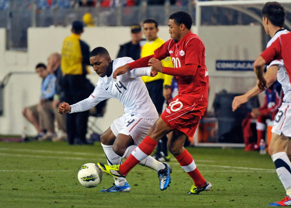 NASHVILLE, TN - MARCH 24: Joe Gyau #14 of the USA and Marcus Haber #10 of Canada fight for a ball in a 2012 CONCACAF Men's Olympic Qualifying match at LP Field on March 24, 2012 in Nashville, Tennessee. (Photo by Frederick Breedon/Getty Images)