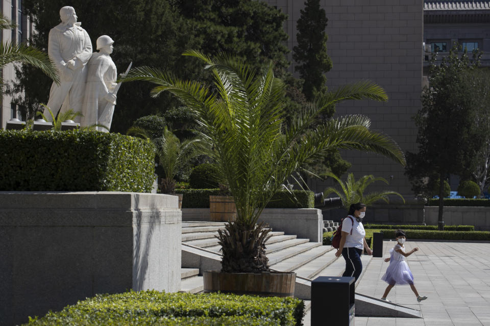 Visitors leave after visiting the military museum in Beijing on Thursday, Sept. 3, 2020. China on Thursday commemorated the 75th anniversary of the end of World War II in the Pacific, during which it endured a brutal invasion and occupation of much of its territory by Japan. (AP Photo/Ng Han Guan)