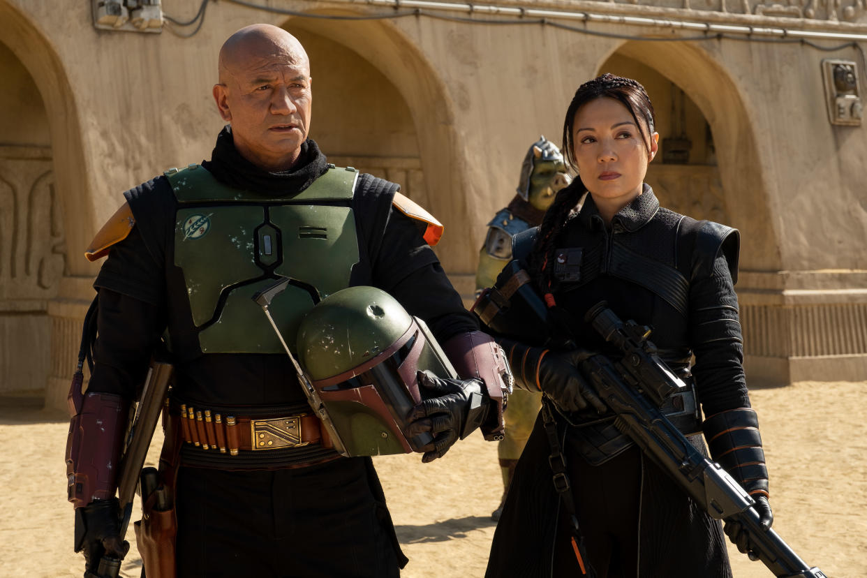 (L-R): Boba Fett (Temuera Morrison) and Fennec Shand (Ming-Na Wen) in Lucasfilm's THE BOOK OF BOBA FETT, exclusively on Disney+. Â© 2021 Lucasfilm Ltd. & â„¢. All Rights Reserved.