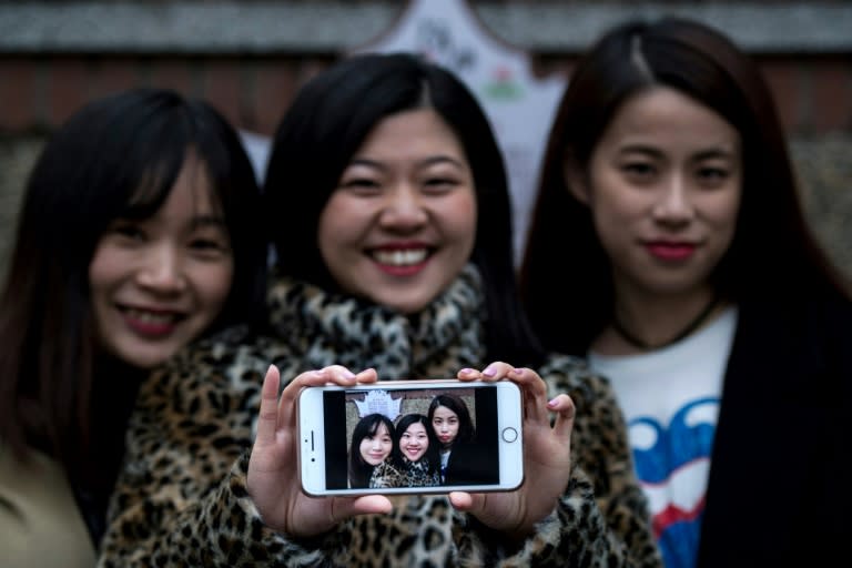 (From L) Hu Dongyuan, Wang Peng and Peng Lin display their selfie in Shanghai