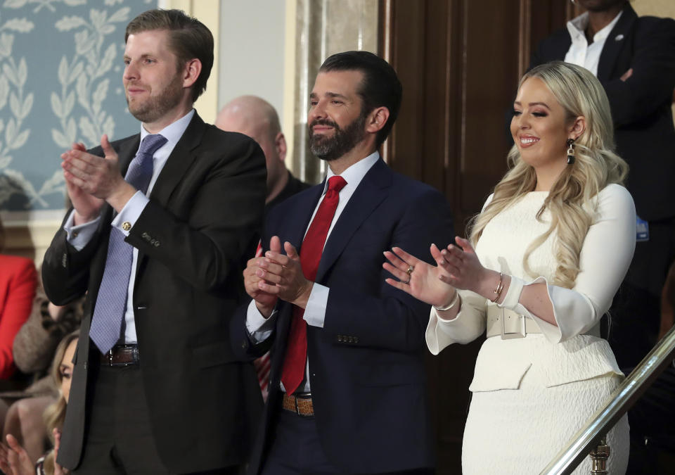 Eric Tump, left, Donald Trump Jr., center and Tiffany trump applaud as President Donald Trump delivers his State of the Union address to a joint session of Congress on Capitol Hill in Washington, Tuesday, Feb. 5, 2019. (AP Photo/Andrew Harnik)