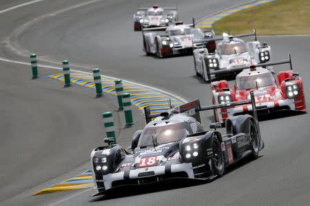 Romain Dumas of France leads the pack with his Porsche 919 Hybrid number 18 during the Le Mans 24-hour sportscar race in Le Mans, central France June 13, 2015. REUTERS/Stephane Mahe