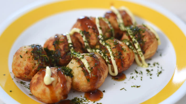 Takoyaki drizzled with takoyaki sauce, Kewpie mayo, and dusted with aonori