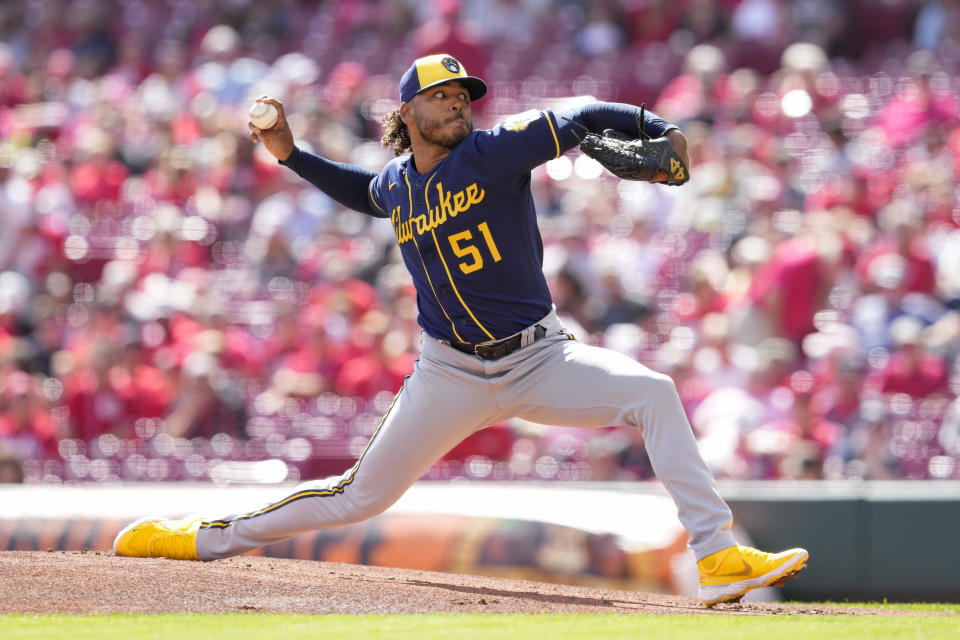 Milwaukee Brewers starting pitcher Freddy Peralta (51) throws during the first inning of a baseball game against the Cincinnati Reds, Sunday, Sept. 25, 2022, in Cincinnati. (AP Photo/Jeff Dean)