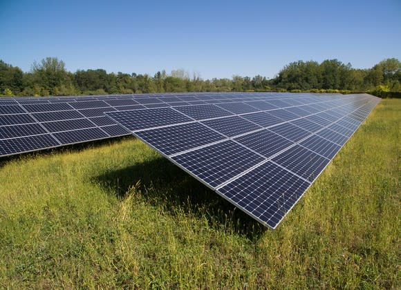 Solar farm in a grassy field.