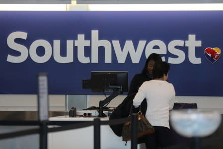 A traveler checks her baggage at the Southwest Airlines terminal at LAX airport in Los Angeles