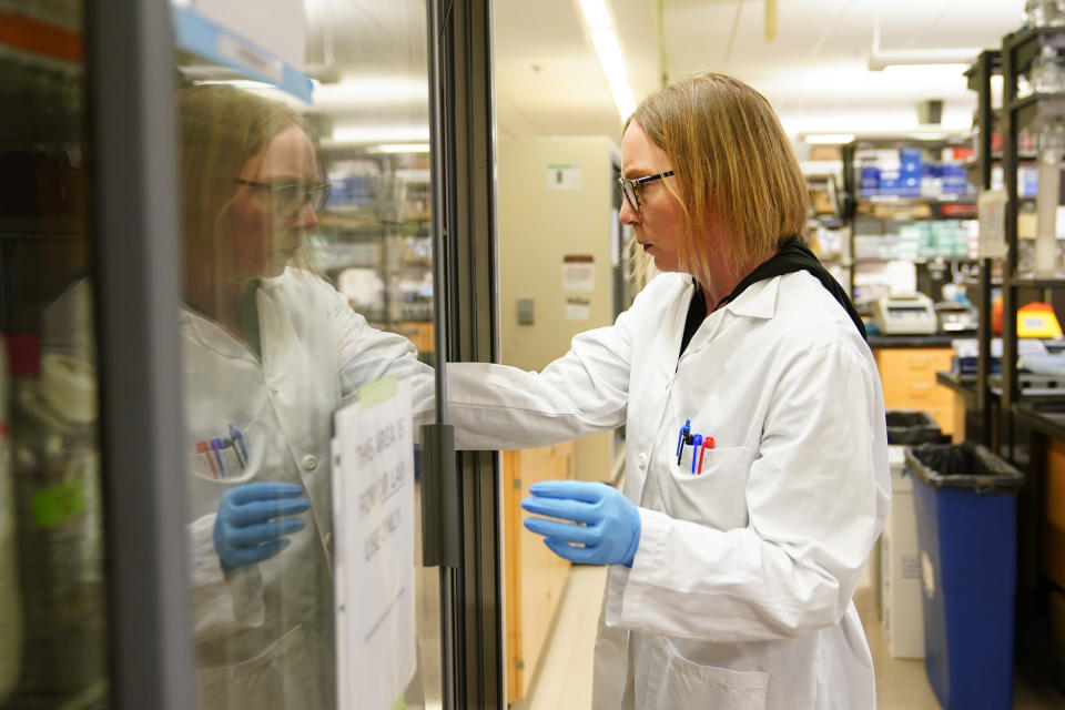 Principal Scientist Denise Cecil retrieves supplies while working at UW Medicine's Cancer Vaccine Institute Thursday, May 25, 2023, in Seattle. Vaccines under development at UW Medicine are designed to work for many patients, not just a single patient. Tests are underway in early and advanced breast cancer, lung cancer and ovarian cancer. Some results may come as soon as next year. (AP Photo/Lindsey Wasson)