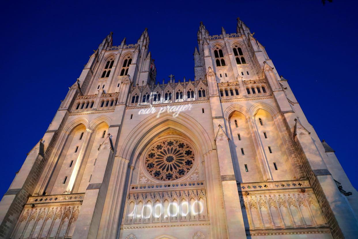 The grim COVID-19 milestone was projected onto the National Cathedral to honor the pandemic's victims. (Photo: Paul Morigi via Getty Images)