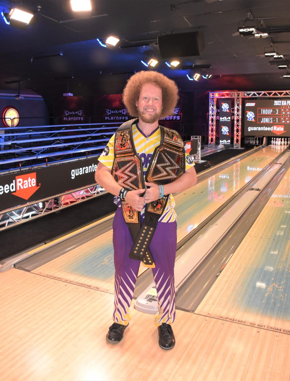PBA bowler Kyle Troup poses with his WWE-style belts in celebration of his successful title defense Sunday, having defeated Tommy Jones to win his ninth career title on May 15, 2022.